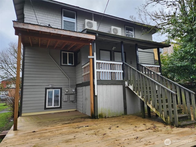 rear view of property featuring a deck and stairway