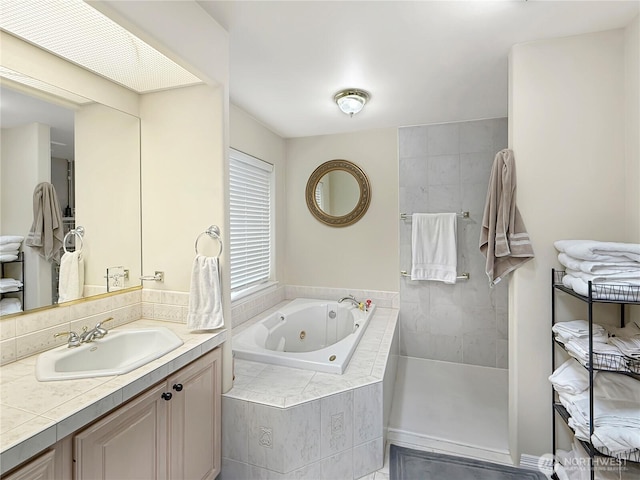 full bathroom featuring a whirlpool tub, a walk in shower, and vanity