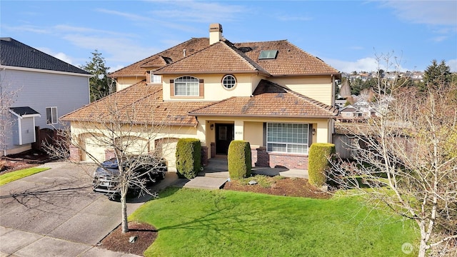 view of front of home with a tile roof, a chimney, an attached garage, driveway, and a front lawn