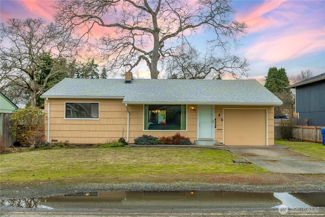 single story home with a garage, a shingled roof, driveway, a front lawn, and a chimney