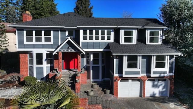 view of front facade featuring driveway, a chimney, a shingled roof, a garage, and brick siding