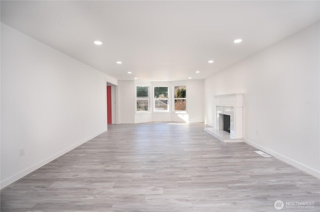6201 53rd Street Ct W, University Place, WA 98467 - unfurnished living room featuring recessed lighting, light wood-type flooring, baseboards, and a fireplace