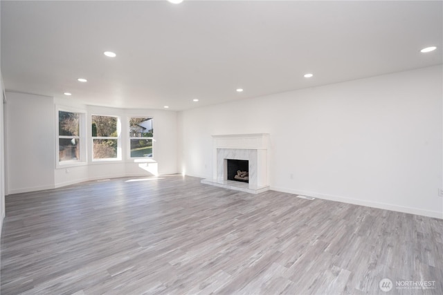 6201 53rd Street Ct W, University Place, WA 98467 - unfurnished living room featuring recessed lighting, a fireplace, and light wood finished floors