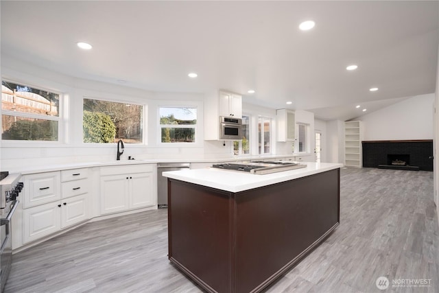 6201 53rd Street Ct W, University Place, WA 98467 - kitchen featuring appliances with stainless steel finishes, white cabinetry, light countertops, and a sink