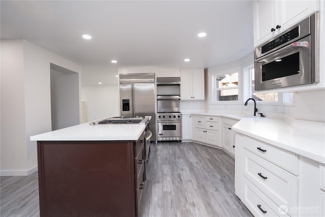 6201 53rd Street Ct W, University Place, WA 98467 - kitchen with white cabinetry, a center island, premium appliances, and a sink