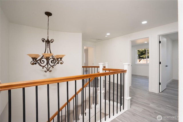 6201 53rd Street Ct W, University Place, WA 98467 - corridor featuring baseboards, recessed lighting, light wood-style floors, a notable chandelier, and an upstairs landing