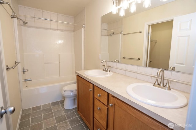 bathroom with toilet, a sink, washtub / shower combination, and tile patterned floors