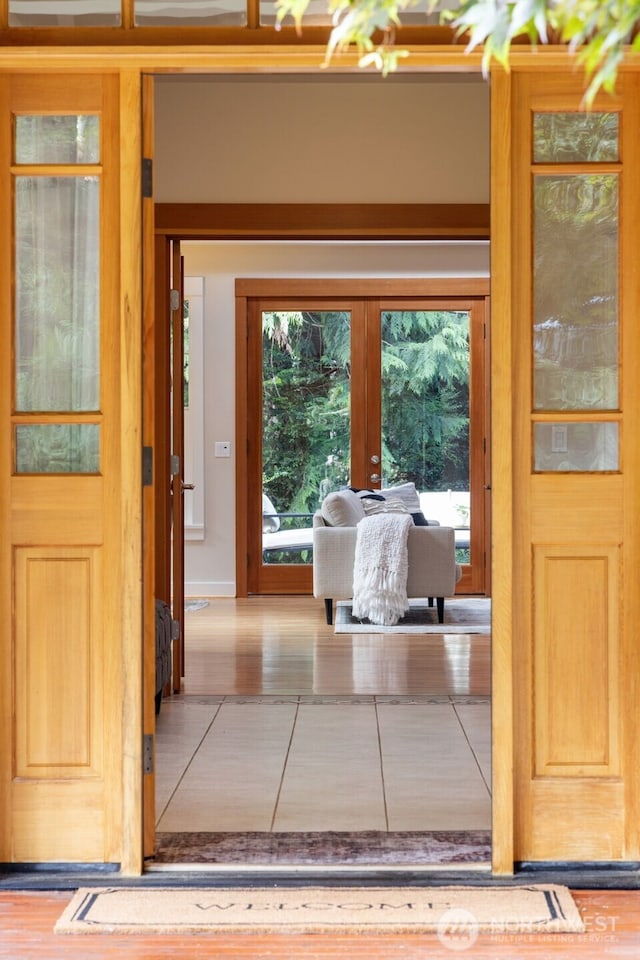 entryway with french doors and tile patterned floors