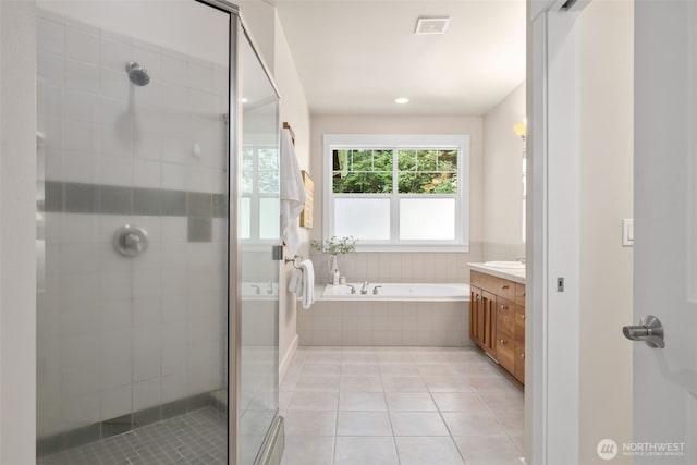 bathroom with visible vents, a shower stall, vanity, a bath, and tile patterned floors