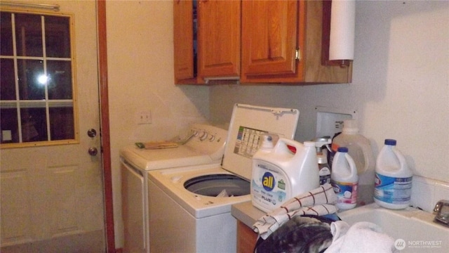 clothes washing area with cabinet space and washing machine and clothes dryer