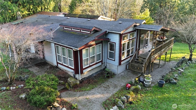 exterior space with roof with shingles
