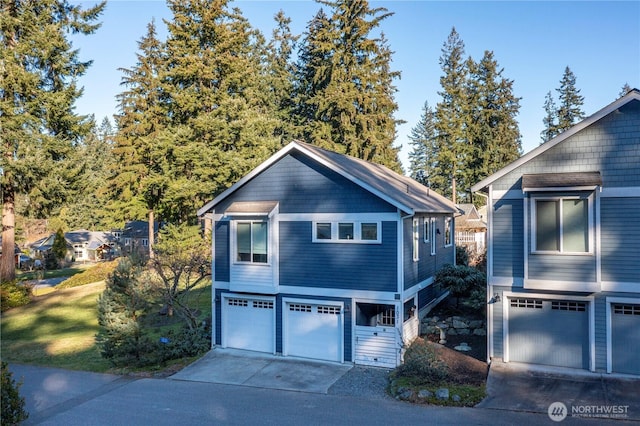 view of front facade featuring concrete driveway and an attached garage