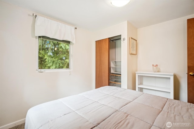 bedroom featuring a closet and baseboards