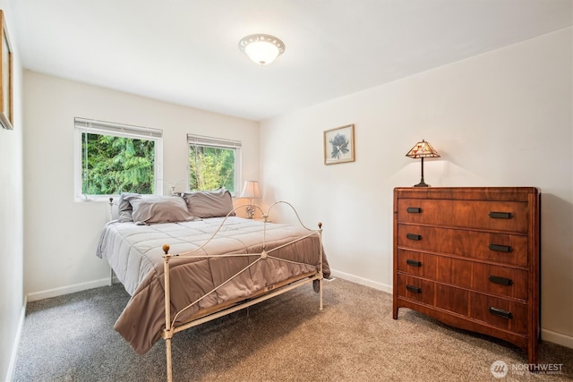 bedroom featuring baseboards and light colored carpet