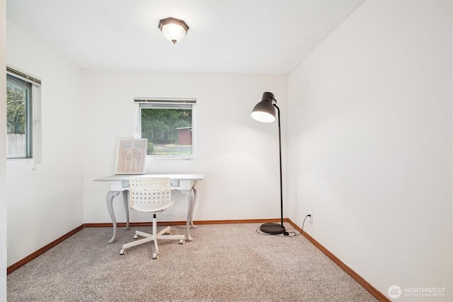 carpeted office space featuring a wealth of natural light and baseboards