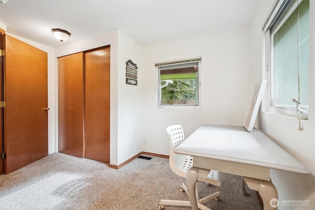 office featuring carpet floors, visible vents, and baseboards