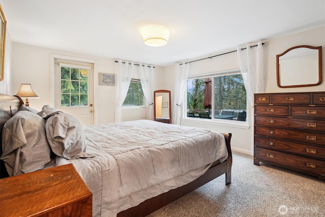 bedroom featuring light carpet and baseboards