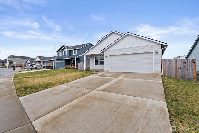 view of front of property with concrete driveway, a residential view, fence, a front lawn, and board and batten siding