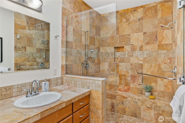 full bathroom featuring vanity and walk in shower