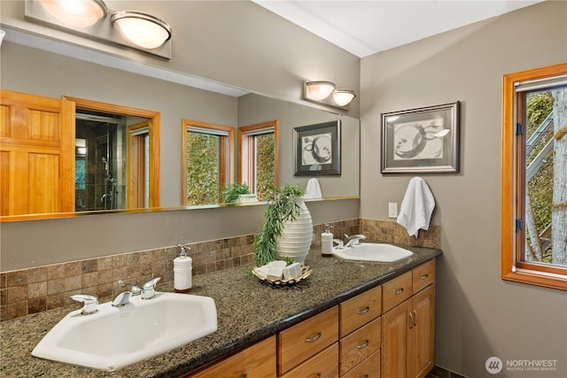 full bath with double vanity and a sink