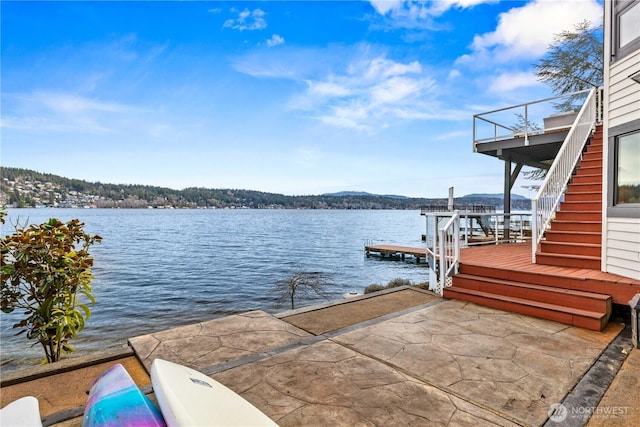 dock area featuring stairs and a water view