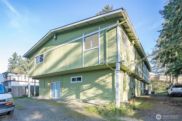 view of side of property featuring fence