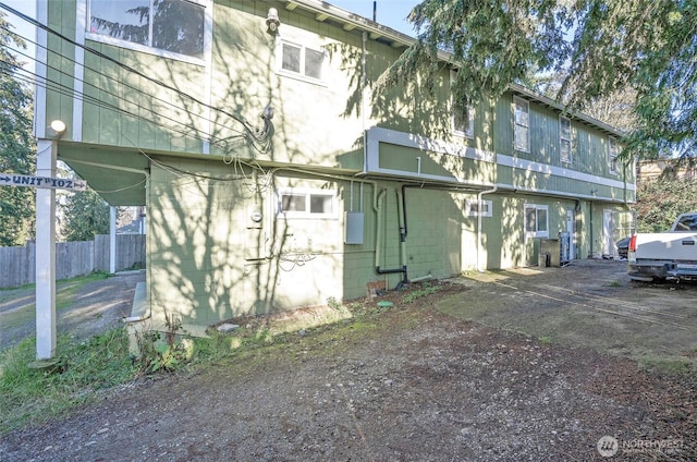 back of house with fence