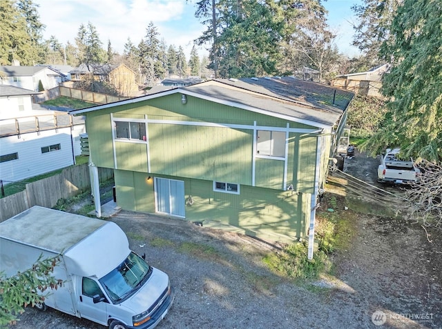 view of side of property featuring fence