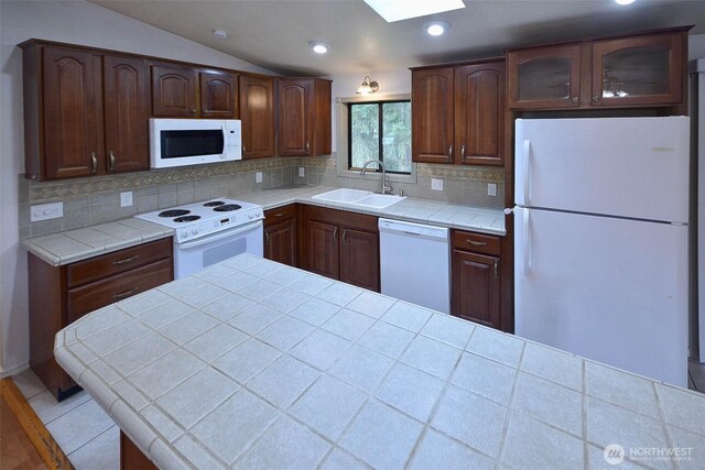 kitchen with white appliances, decorative backsplash, tile countertops, glass insert cabinets, and a sink