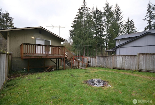 view of yard featuring a deck, a fire pit, fence, and stairway