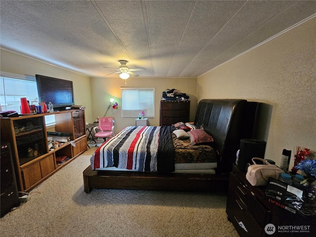 carpeted bedroom with ceiling fan and a textured ceiling