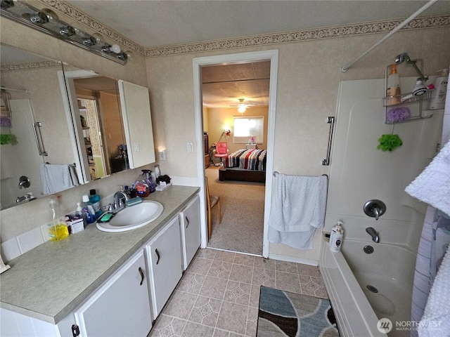 ensuite bathroom with shower / washtub combination, connected bathroom, and vanity