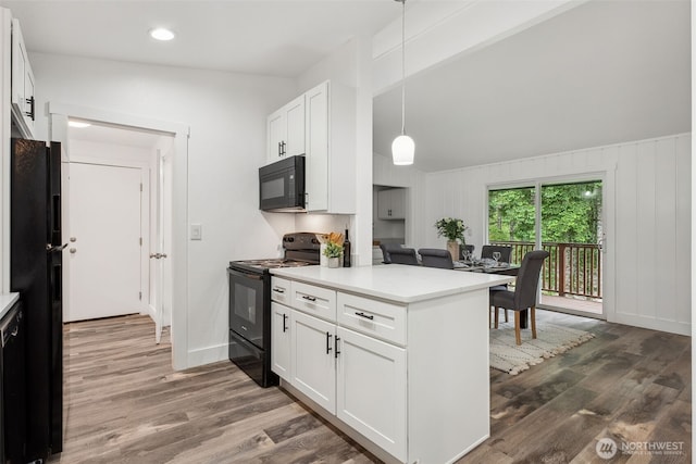 kitchen featuring black appliances, dark wood finished floors, white cabinets, and light countertops