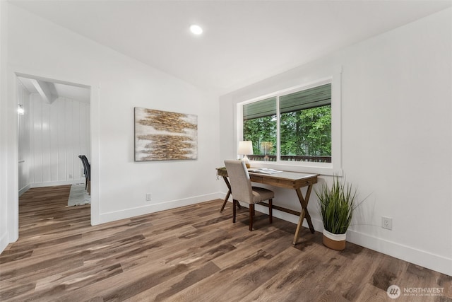 office space featuring lofted ceiling, baseboards, and dark wood-type flooring