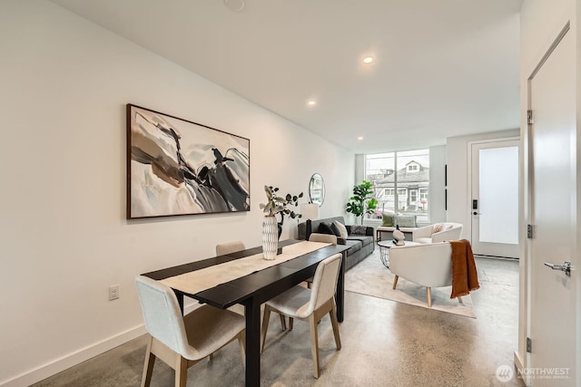 dining space featuring finished concrete floors, recessed lighting, and baseboards