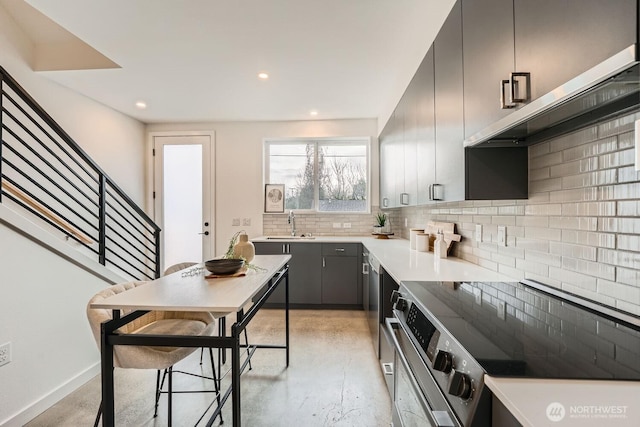 kitchen with modern cabinets, stainless steel electric range, gray cabinetry, backsplash, and recessed lighting