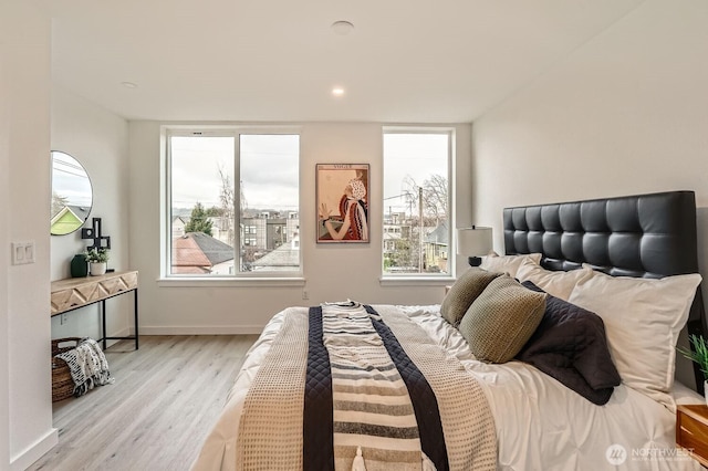 bedroom featuring light wood-type flooring and baseboards