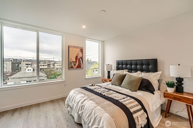 bedroom featuring light wood-type flooring, baseboards, and recessed lighting