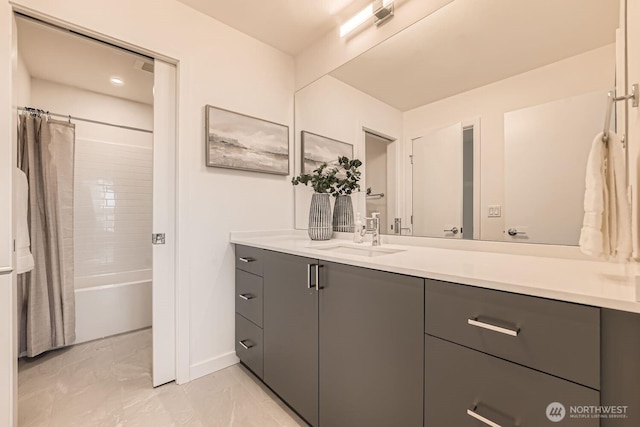 full bathroom with marble finish floor, vanity, baseboards, and shower / bath combo with shower curtain