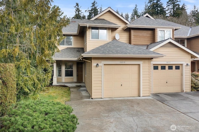 view of front of house featuring a garage, driveway, and roof with shingles