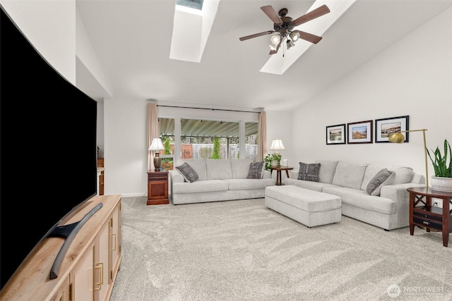 living area with a skylight, carpet, high vaulted ceiling, and ceiling fan