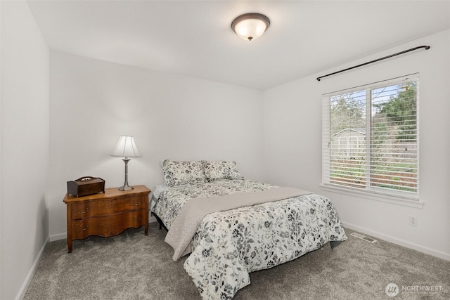 carpeted bedroom featuring visible vents and baseboards