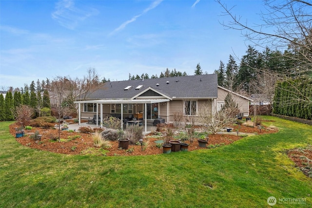 rear view of house with a patio area and a lawn