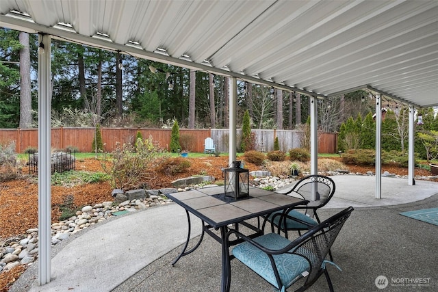 view of patio with outdoor dining area and fence