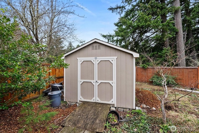 view of shed with a fenced backyard