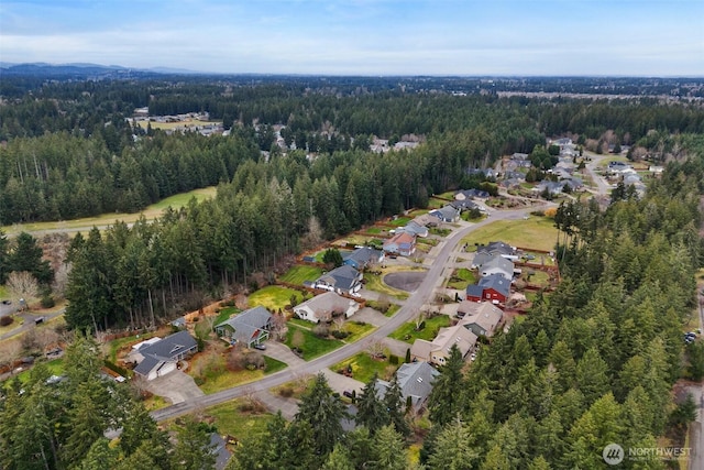 drone / aerial view with a forest view and a residential view