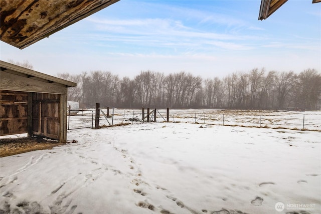 yard covered in snow with fence