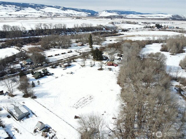 snowy aerial view featuring a mountain view