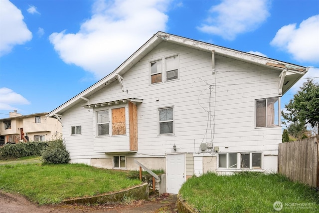 back of house with a yard and fence