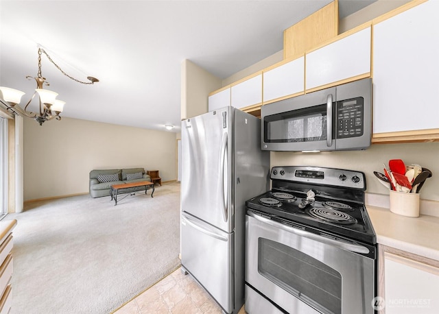 kitchen with white cabinets, light colored carpet, stainless steel appliances, light countertops, and pendant lighting